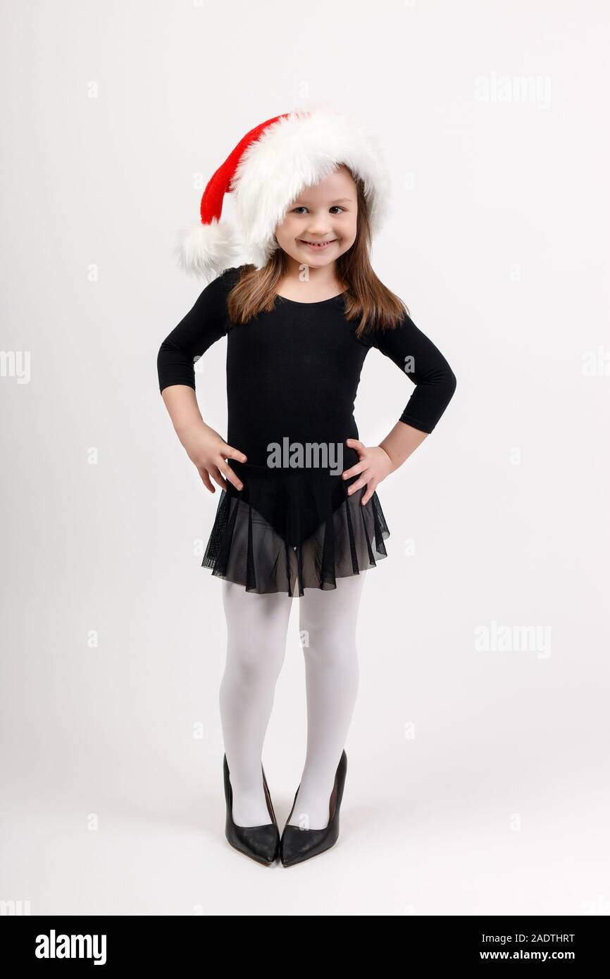 Little girl in ballerina costume and santa claus hat is standing and  smiling. Concept for advertisements about ballet and New Year and Christmas  celeb Stock Photo - Alamy
