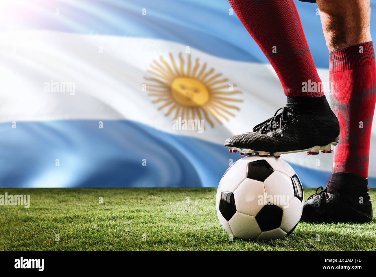 Close up legs of Argentina football team player in red socks, shoes on  soccer ball at the free kick or penalty spot playing on grass Stock Photo -  Alamy