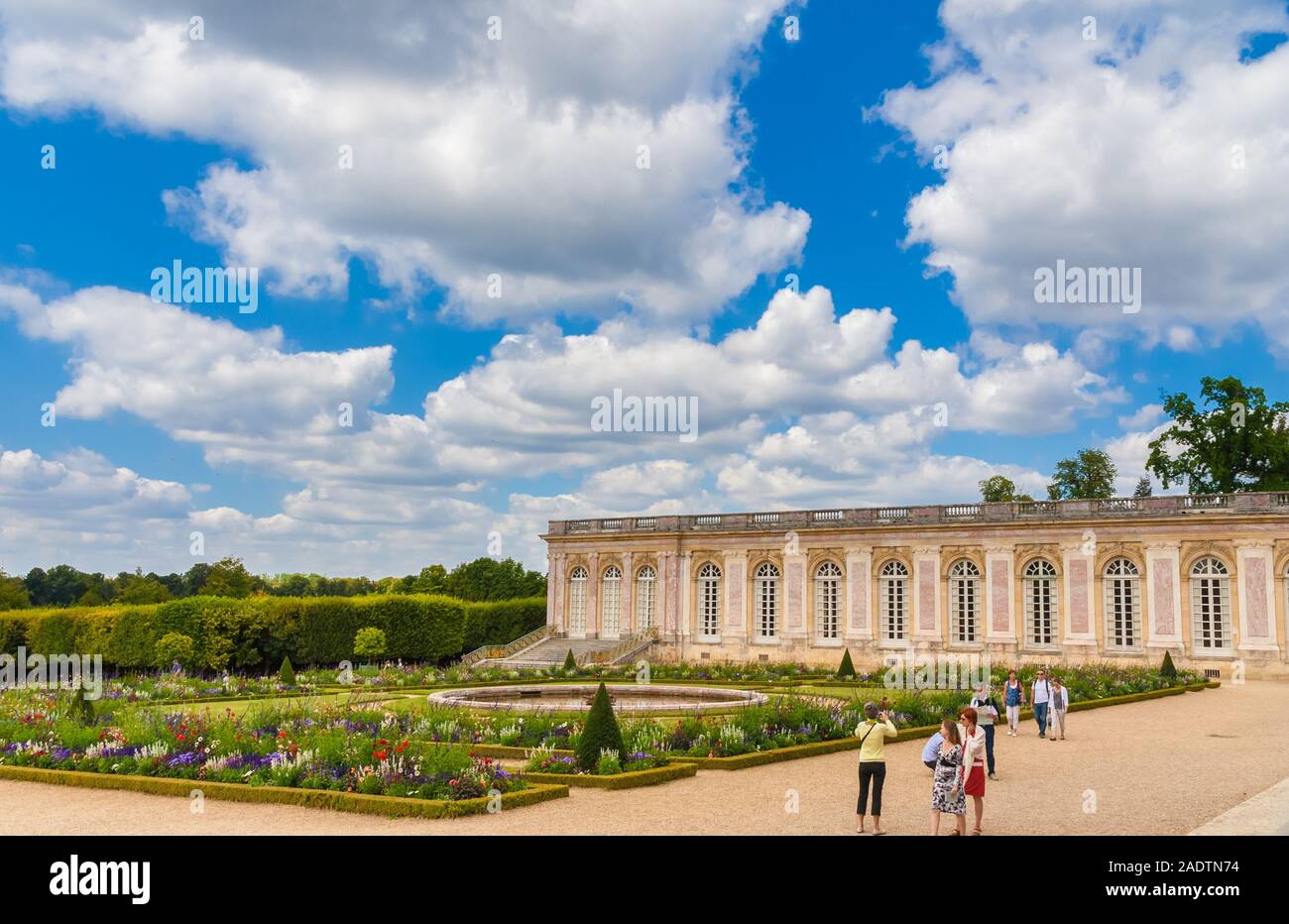 Lovely view of the orderly French garden with the Cotelle Gallery in the north wing of the Grand Trianon Palace in the background. The outdoor setting... Stock Photo