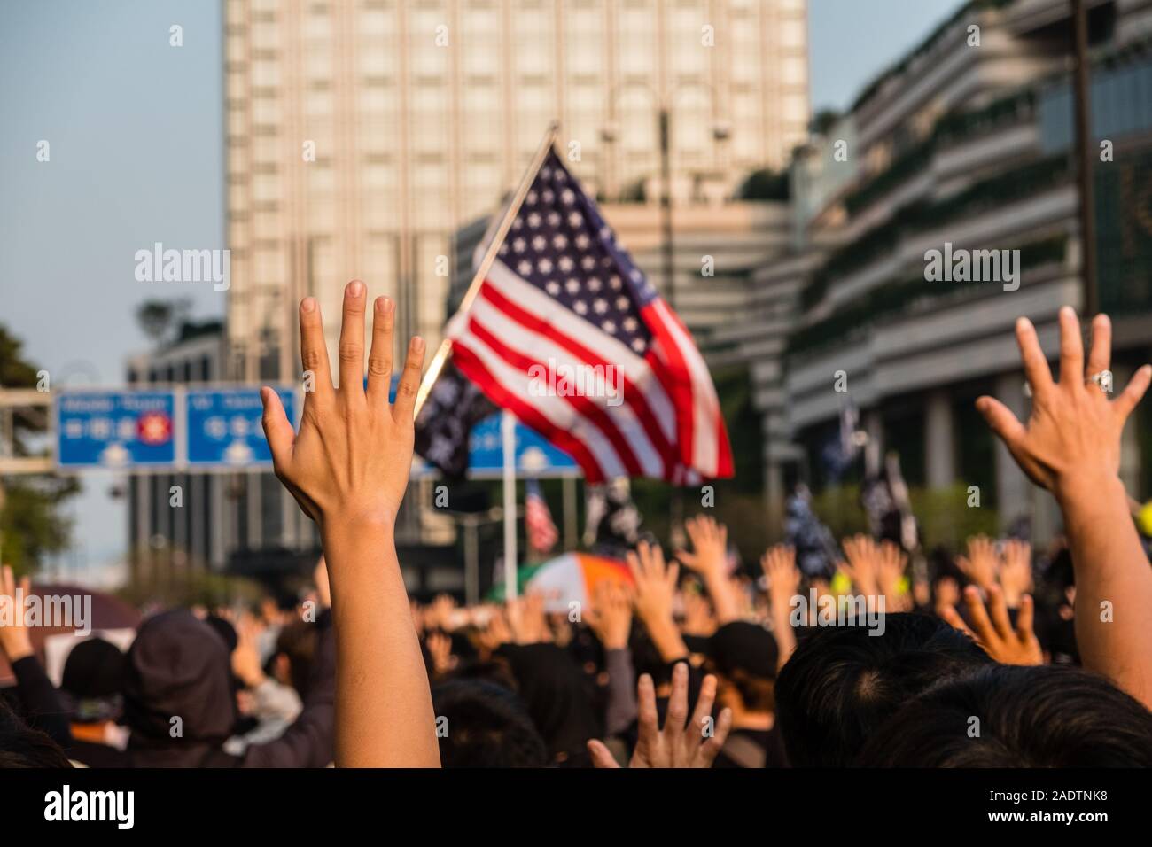HongKong - December 01, 2019: Crowd of people on demonstration during the 2019 protests in Hongkong holding up hand as symbol for Five Demands Stock Photo