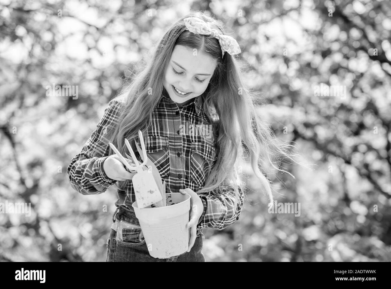 Enjoying her work with plants. spring village country. little girl kid