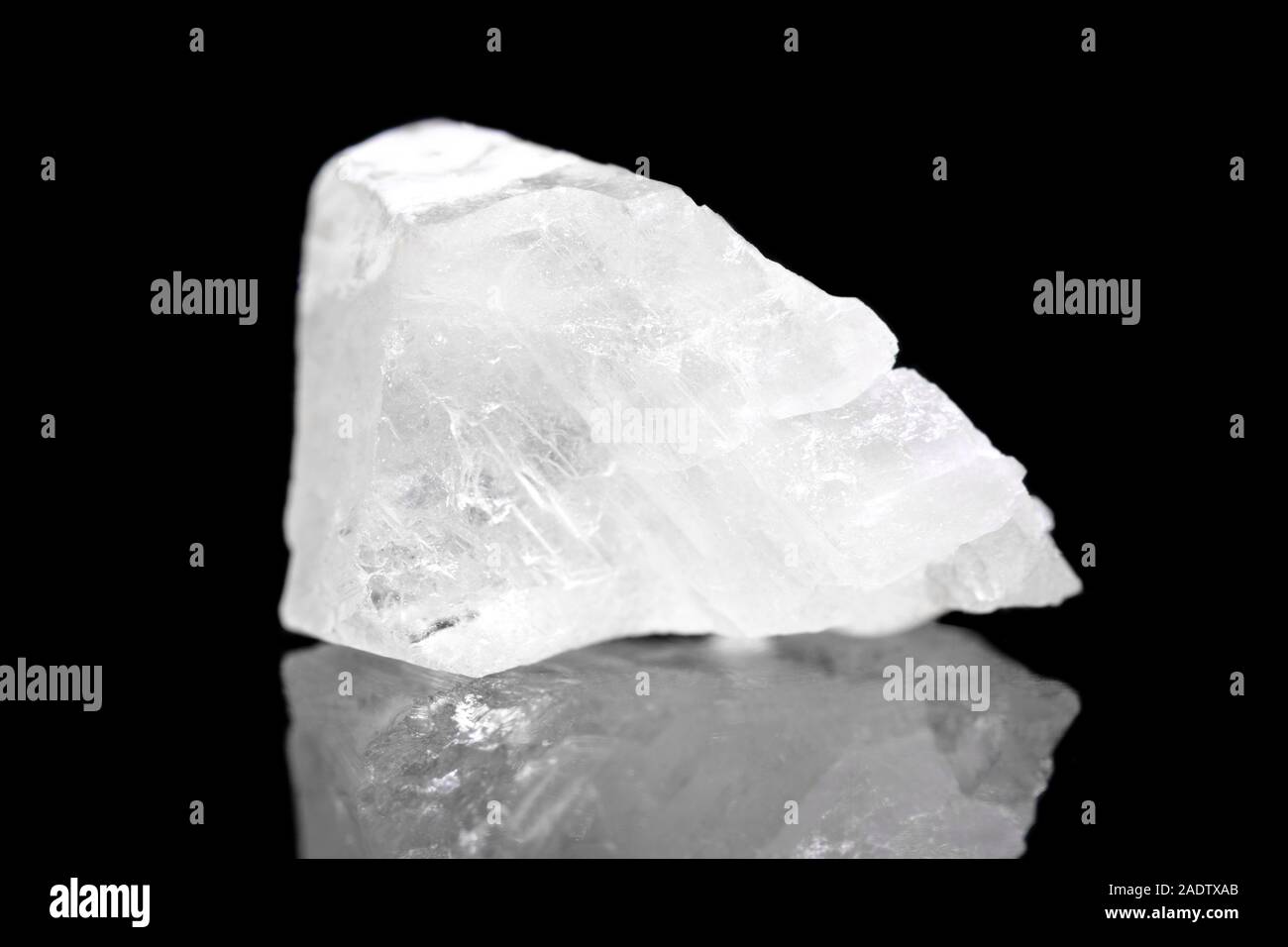 White Calcite mineral stone in front of black background, polymorph