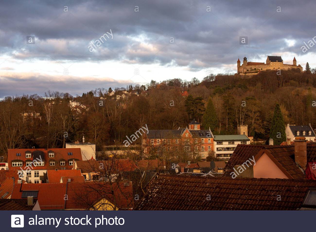 A beautiful winter sunset across the city of Coburg in Bavaria; Germany, with the castle known as Veste Coburg on a hill in the background Stock Photo