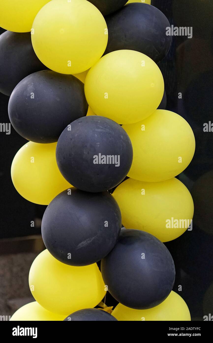 Yellow and black balloons for party decor Stock Photo - Alamy