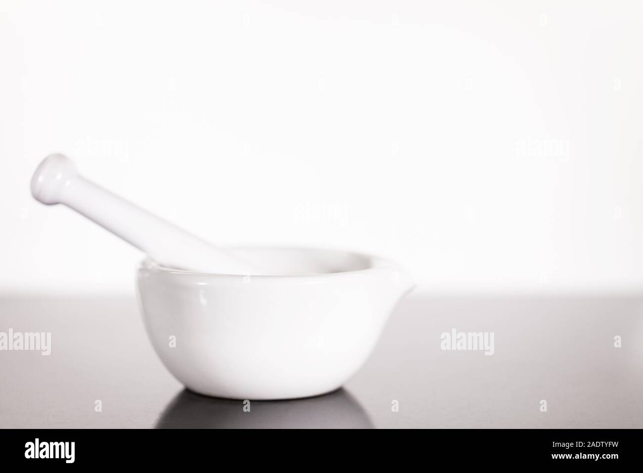White Ceramic Mortar With Pestle Against White Background