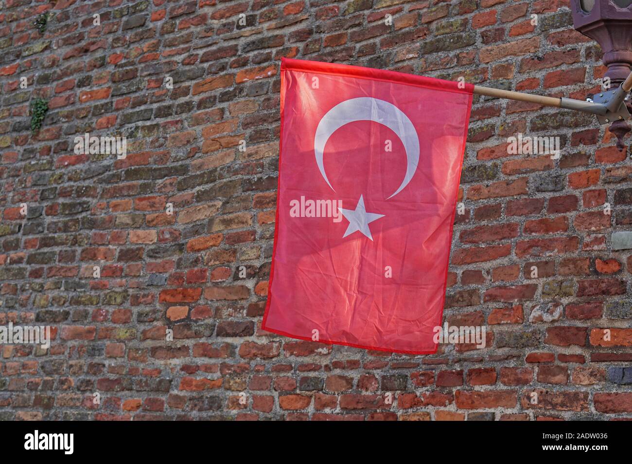 Official Turkey flag with star and crescent at brick wall Stock Photo