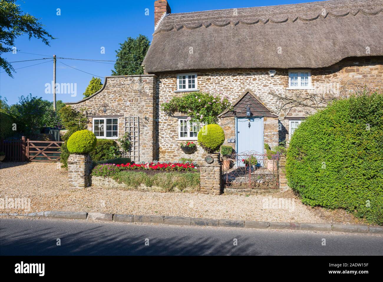 An old period roadside thatched detached cottagein Sandy Lanel Wiltshire England UK Stock Photo