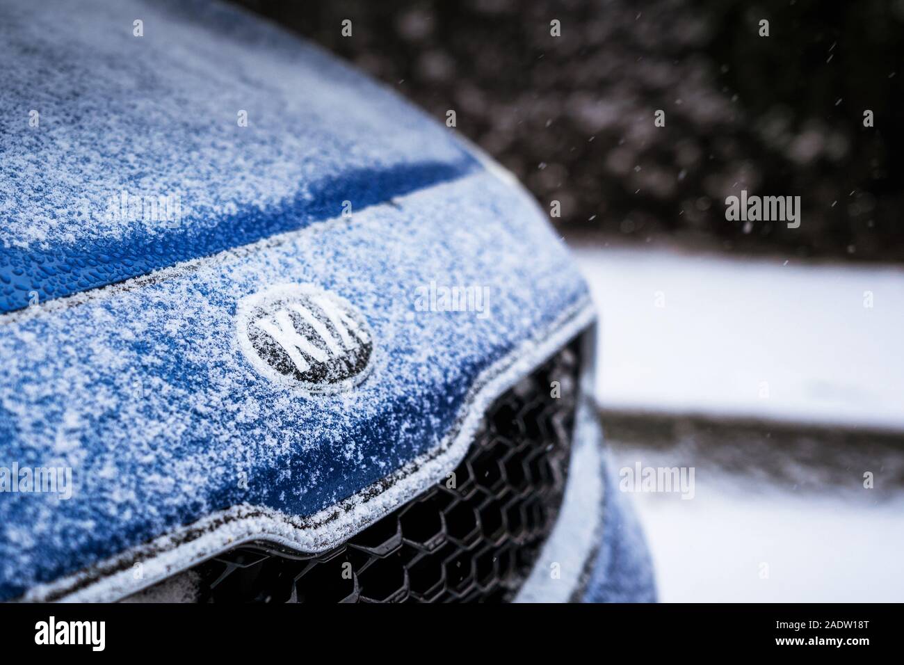 Minsk, Belarus - November 26, 2019: Kia logo in the bonnet of Kia car with snow in winter Stock Photo