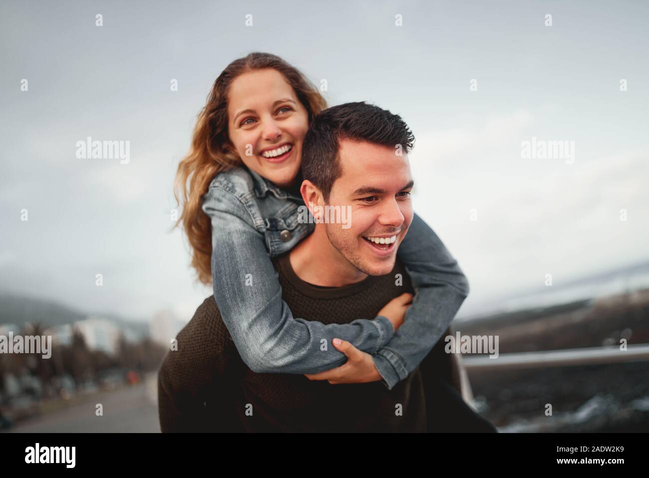 Young Man Giving Woman Piggyback Outdoors, Stock image