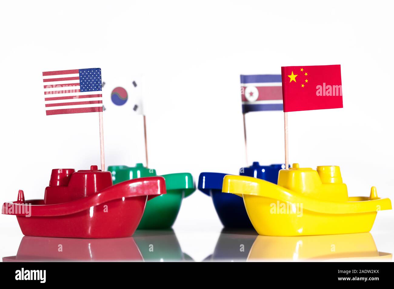 four ships with the flags of united states, russia, north and south korea, concept like border conflict, war or peace with protecting power Stock Photo