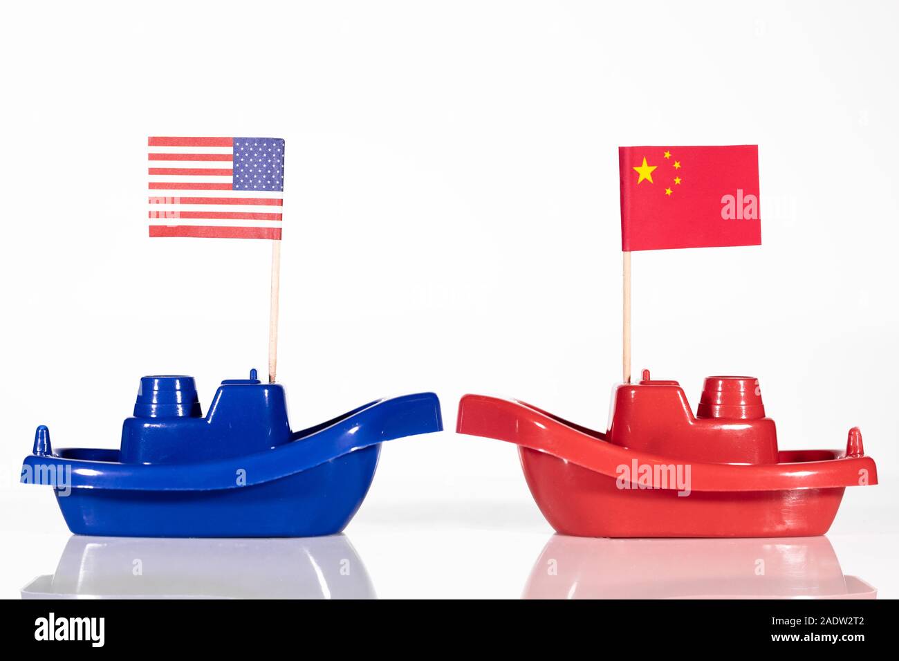 ships with the flags of united states and china in front of white background Stock Photo