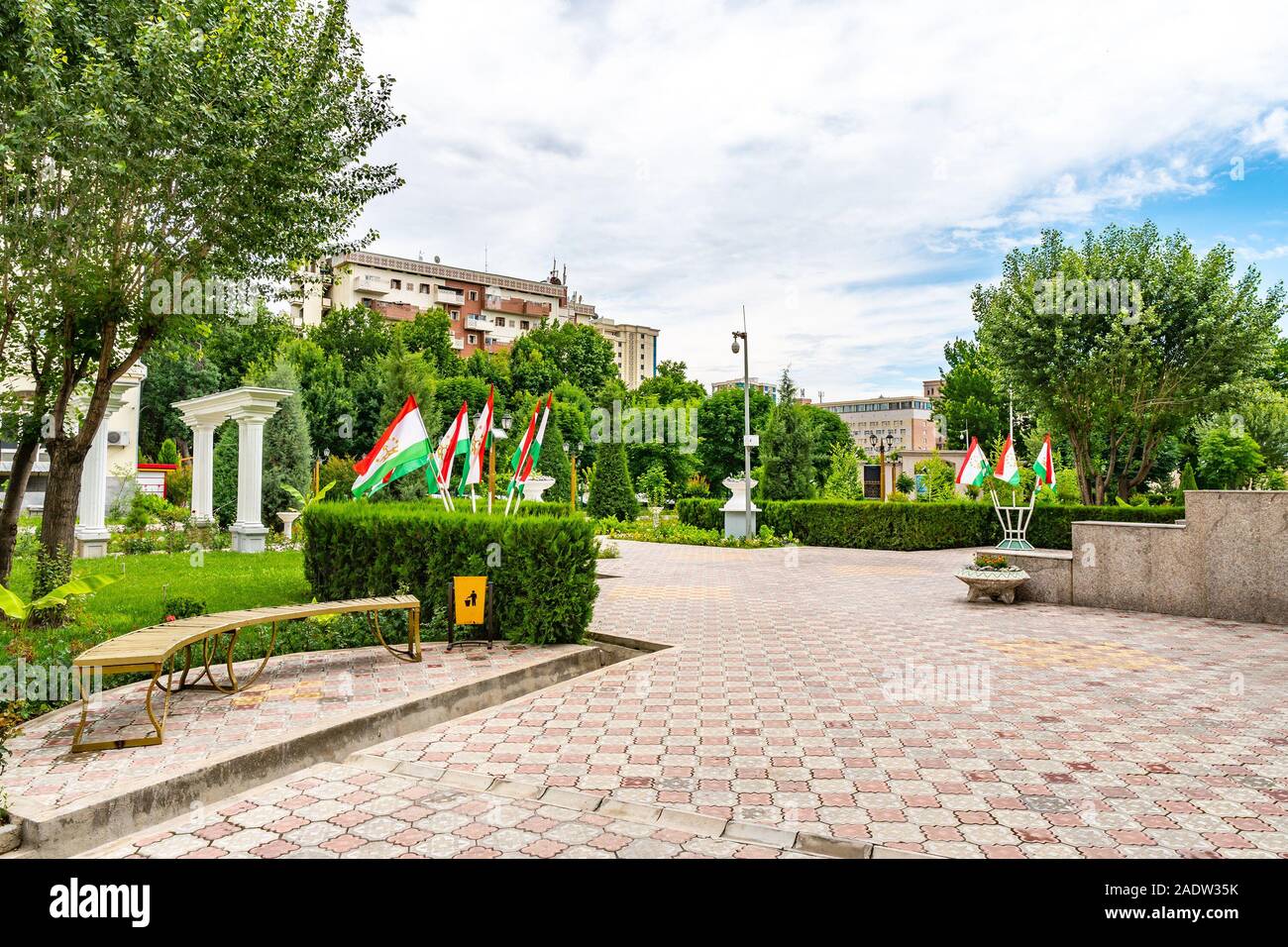 Dushanbe Amphitheater Park Picturesque Garden View with Tajikistan Flags at Ismoil Somoni Avenue on a Cloudy Rainy Sky Day Stock Photo
