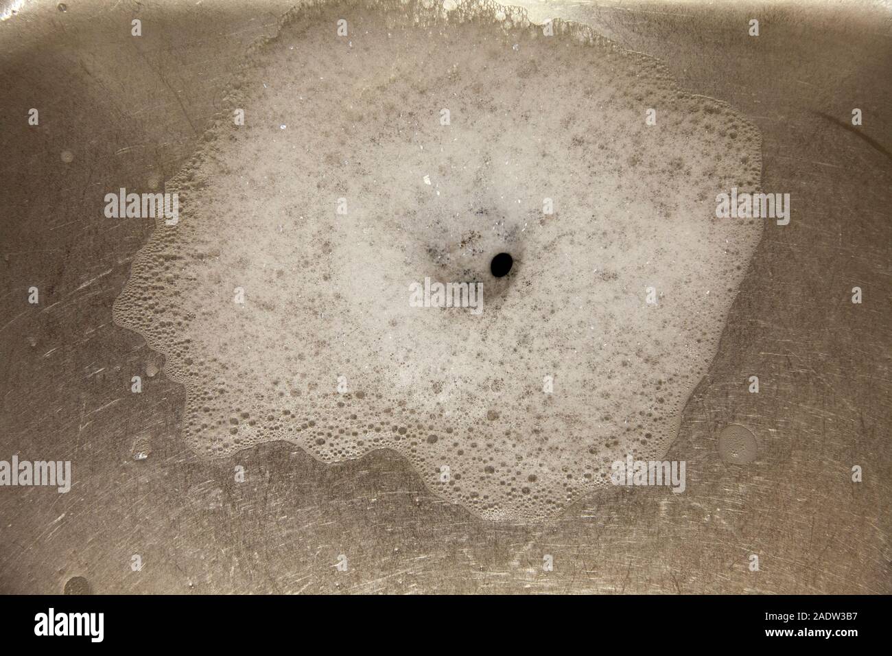 Foam Around Plughole in Sink Stock Photo
