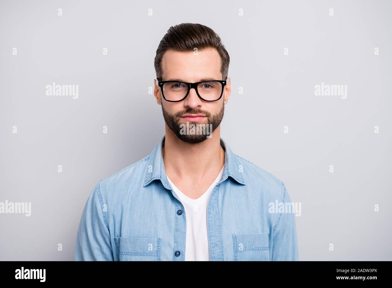Closeup photo of amazing macho guy serious perfect appearance neat hairstyle  bristle young promoted boss chief wear specs casual denim outfit isolated  Stock Photo - Alamy
