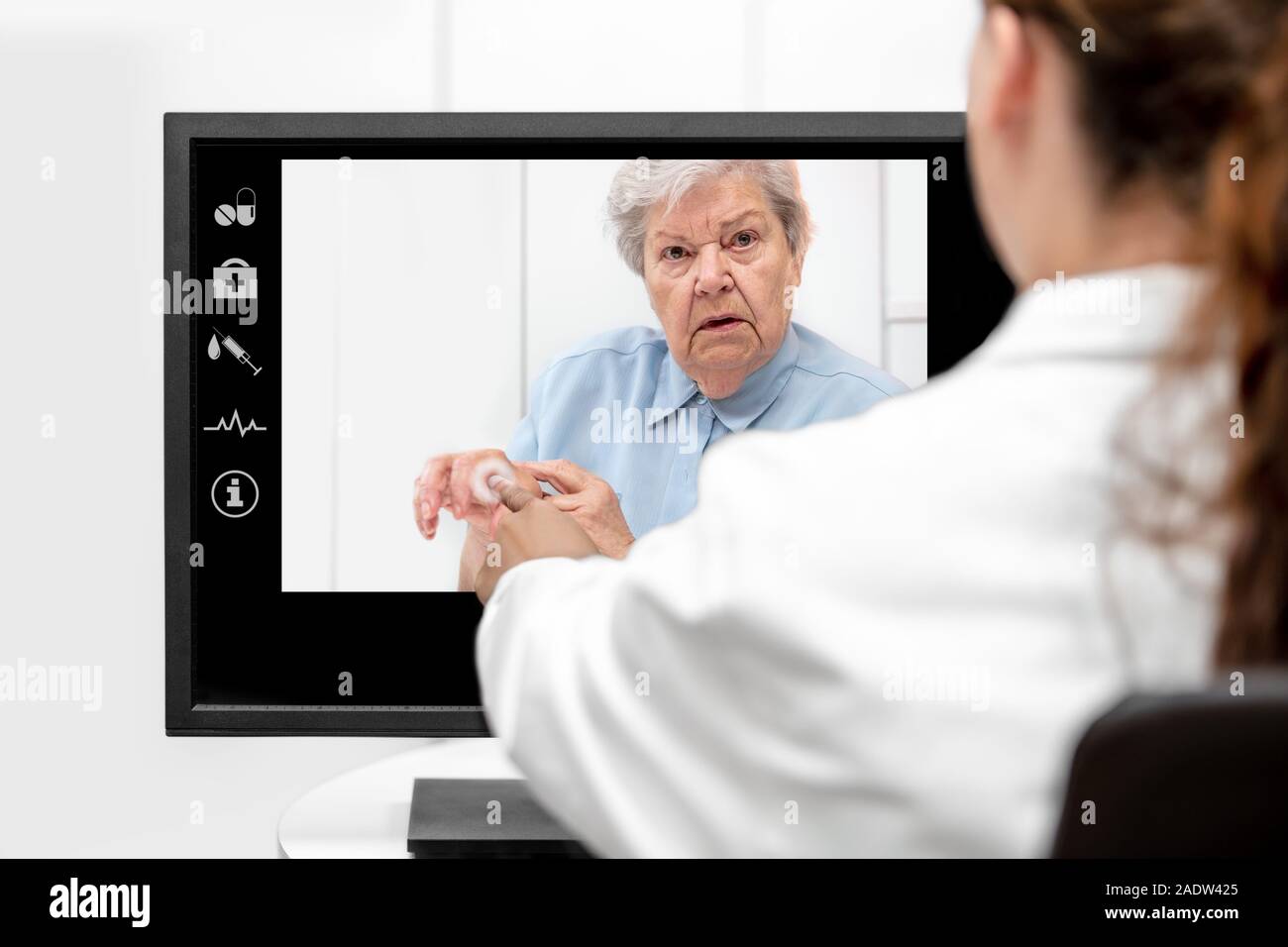 Telemedicine and elderly care with a senior woman and a doctor in front of a monitor, medical consultation Stock Photo