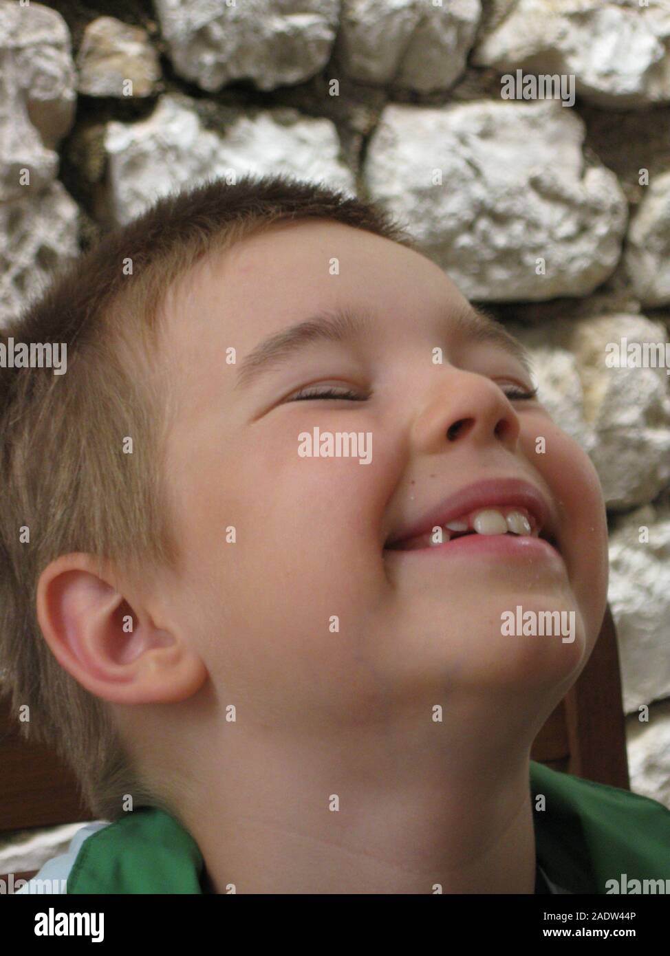 Boy portrait, stony background, funny face expression. Stock Photo