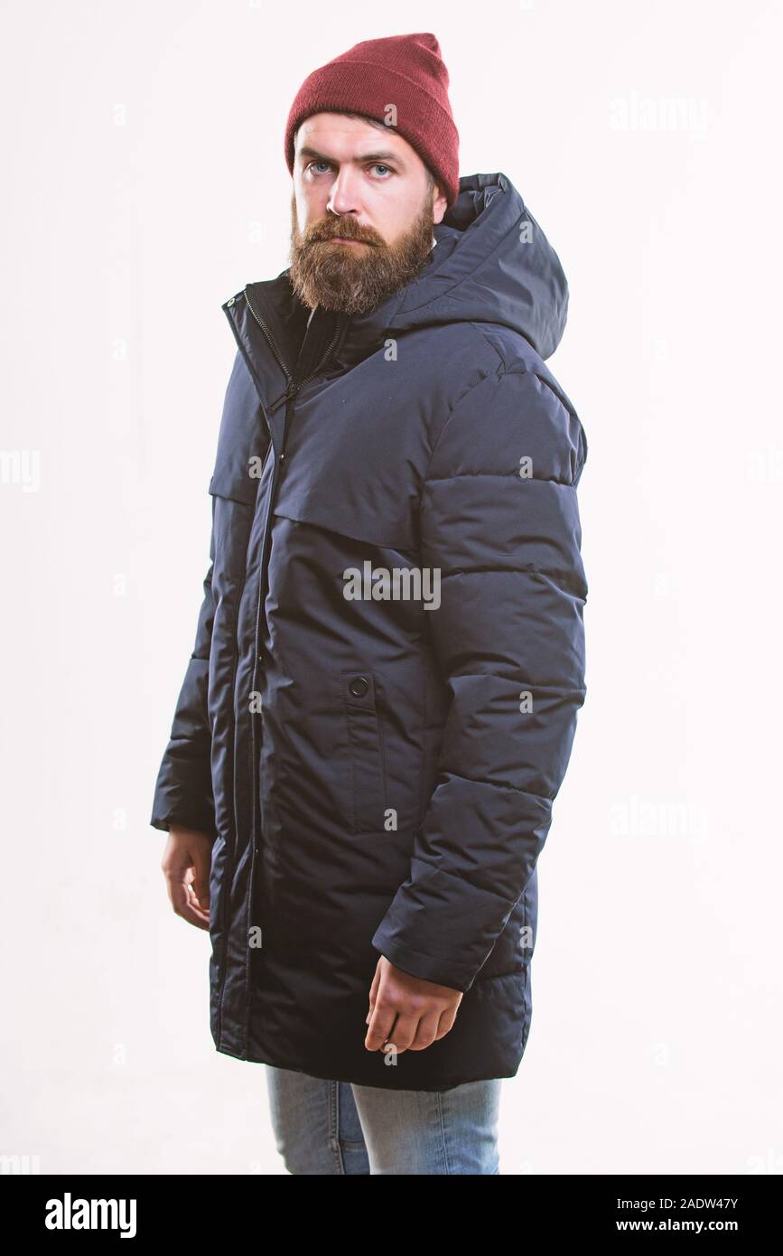 Stylish and comfortable. Man bearded hipster posing confidently in warm  black jacket or parka. Hipster modern fashion. Guy wear hat and black  winter jacket. Hipster style menswear. Hipster outfit Stock Photo by ©