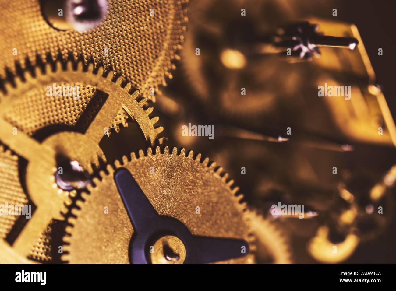 Details of a brassy Clockwork mechanism, cogwheels and components Stock Photo