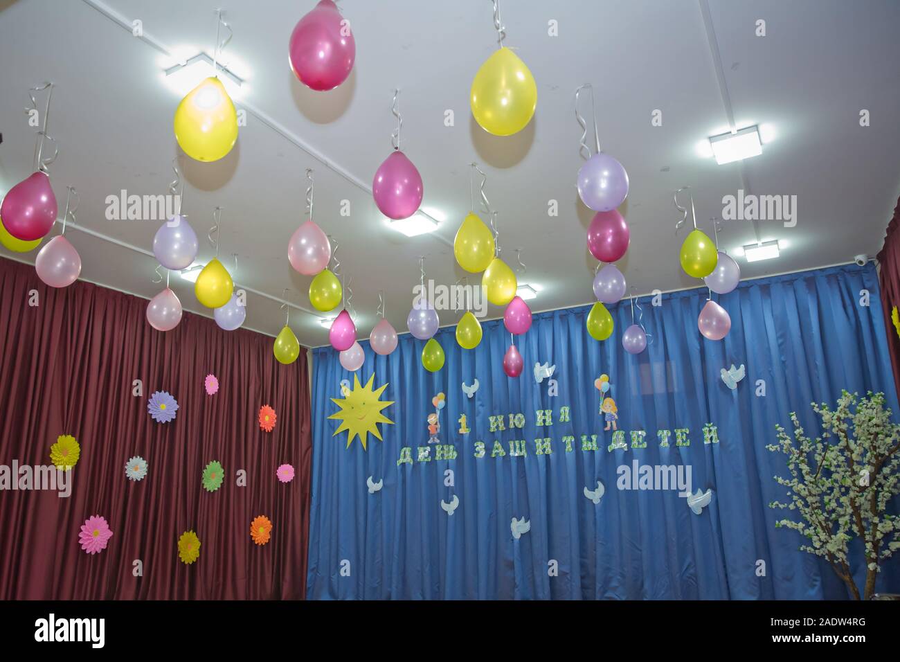 Pink And Yellow Balloons Float On The White Ceiling In The Room