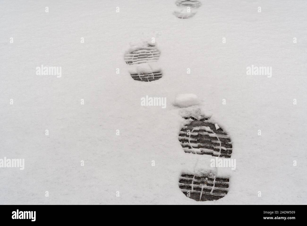 Footprints in fresh snow background, great concept for winter footwear