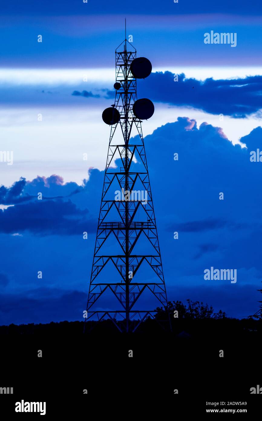 Telecommunications tower Sunrise silhouette Stock Photo