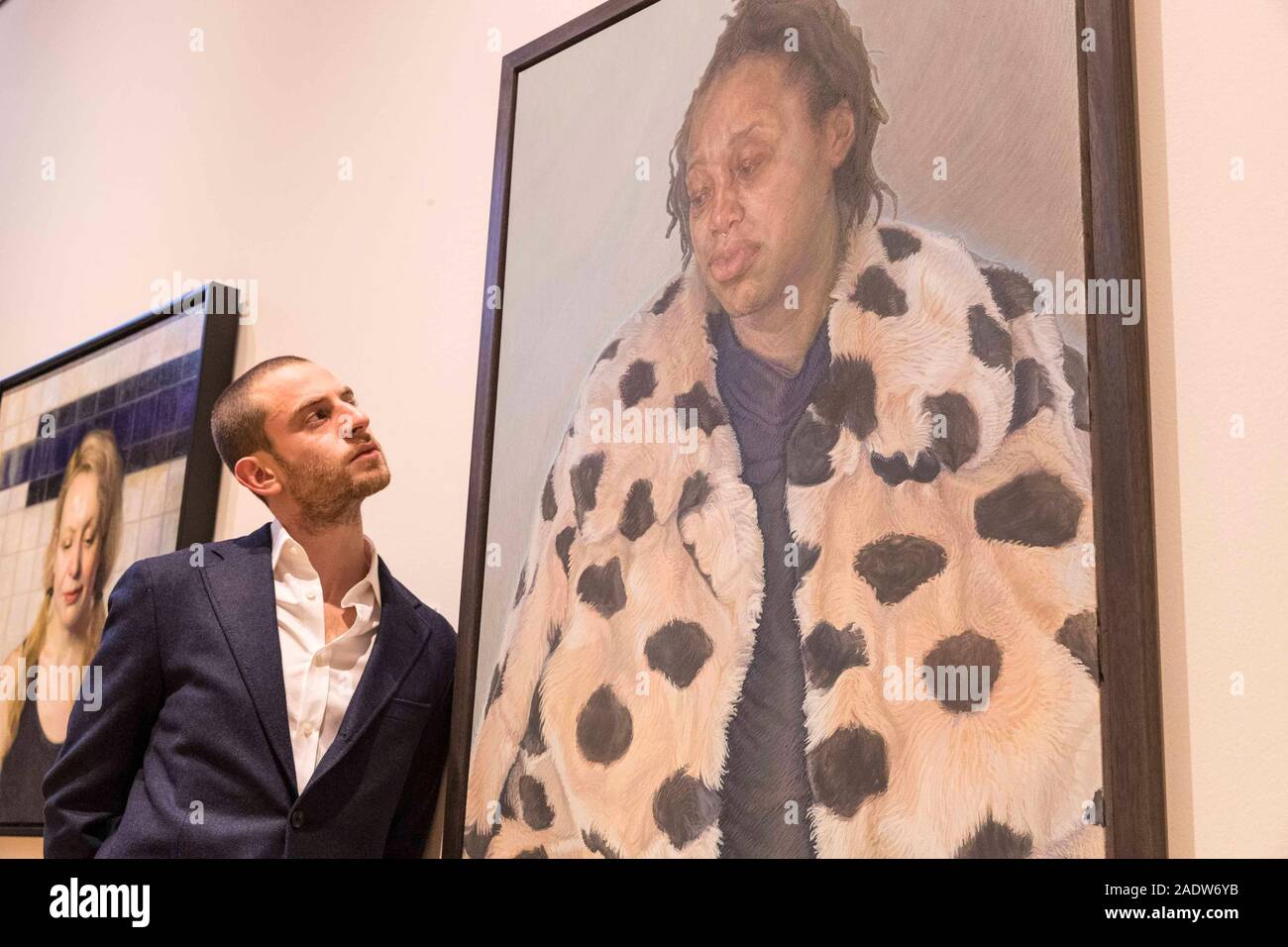 Edinburgh, United Kingdom. 05 December, 2019 Pictured: Charlie Schaffer and Imara in her Winter Coat at the BP Portrait Award Exhibition. The BP Portrait Award is the most prestigious portrait painting competition in the world and represents the very best in contemporary portrait painting. The BP Portrait Award is now in its tenth year at the Scottish National Portrait Gallery. Credit: Rich Dyson/Alamy Live News Stock Photo
