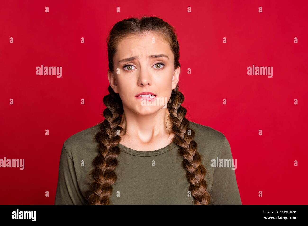 Photo of pretty lady long braids biting lips eyes full of fear ...