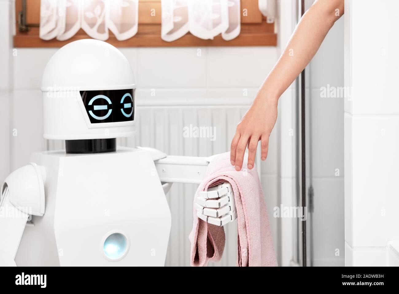 service Ambient Assisted Living robot is giving a towel to an women under the shower in the bathroom Stock Photo