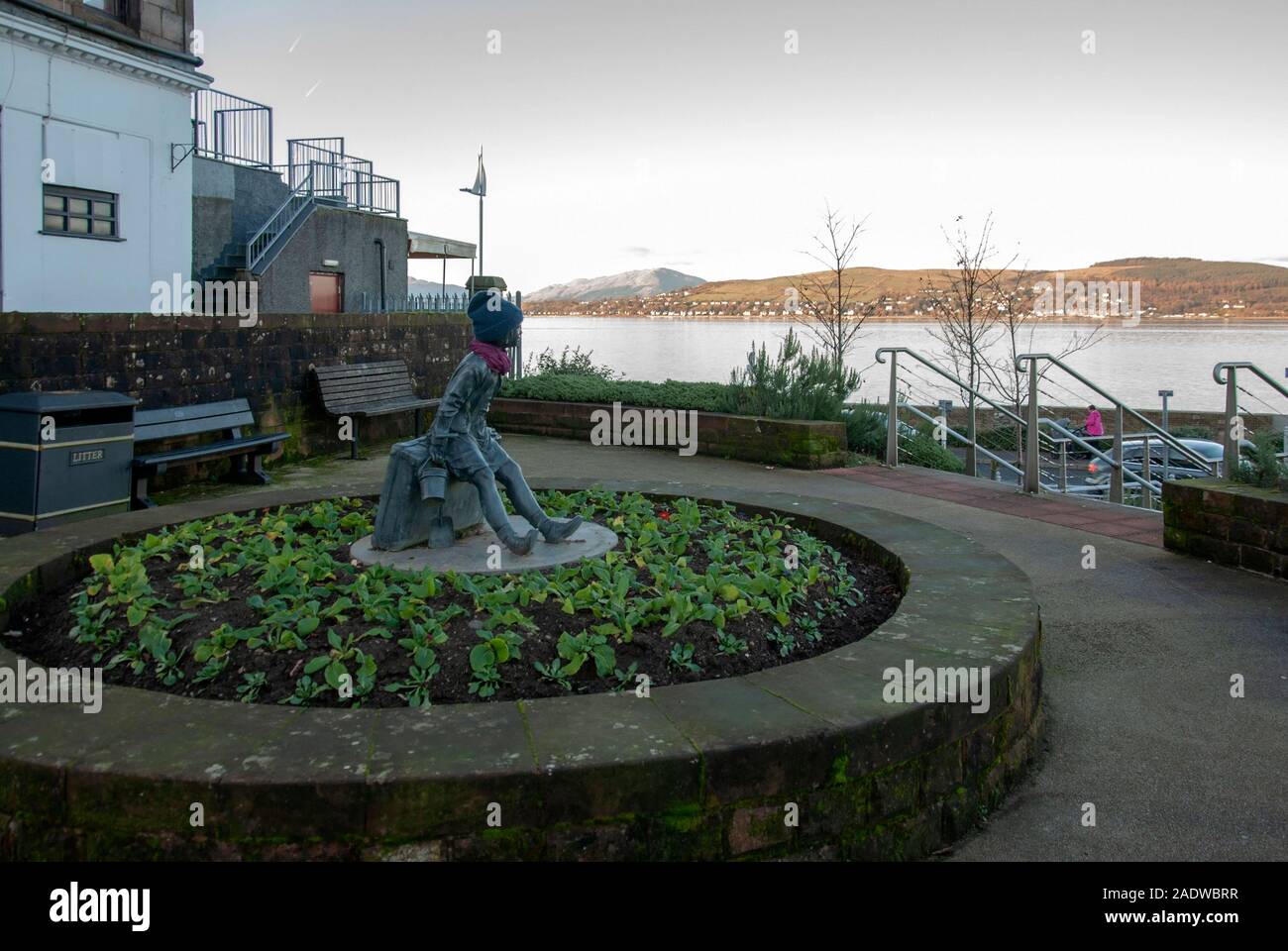 Girl on A Suitcase Bronze Statue Flower Bed Kempock Street Gourock Inverclyde Scotland United Kingdom 2011 Angela Hunter artist sculptor sculpture fig Stock Photo