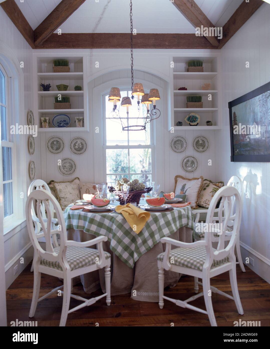 White painted hoop back chairs at table with green+white checked cloth