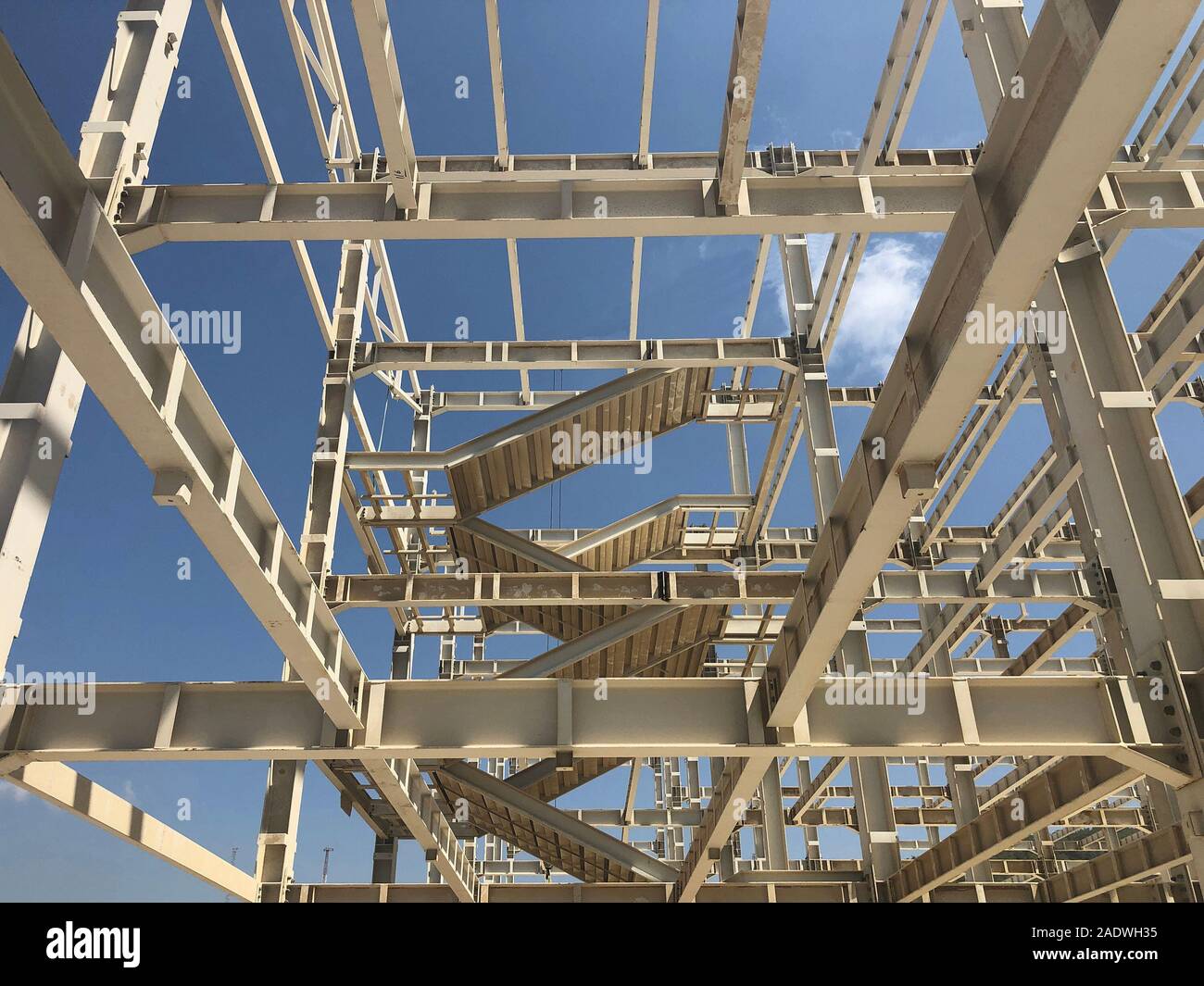 Metal frame of prefabricated multi-storey building. Metal pillars, beams, diagonal bracings and ladders Stock Photo