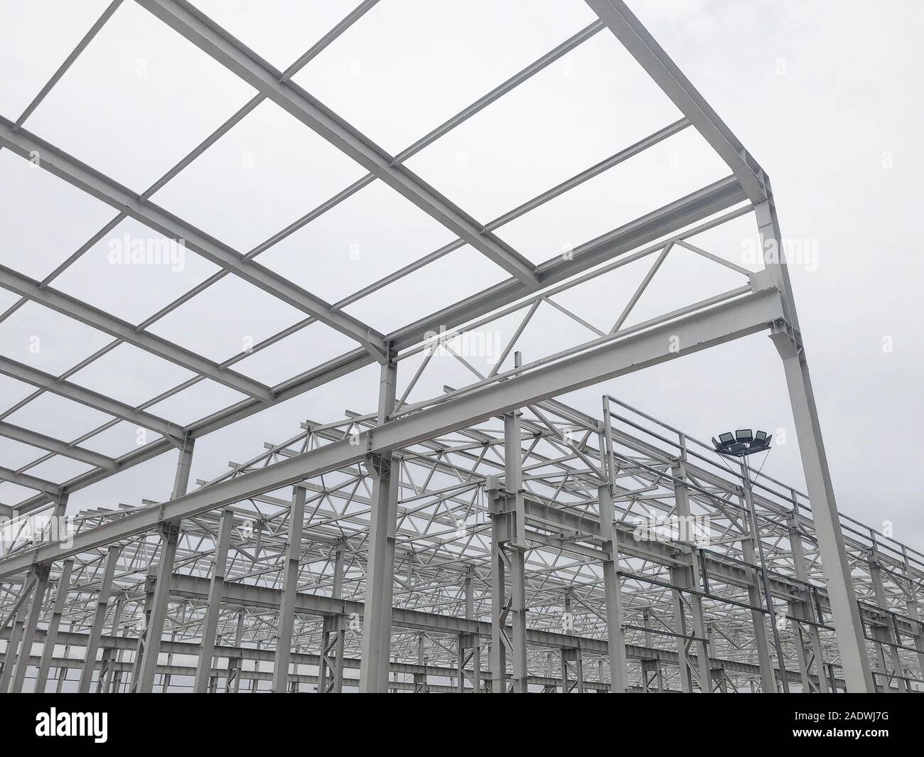 Metal frame of prefabricated multi-storey building. Metal pillars, beams and diagonal bracings Stock Photo