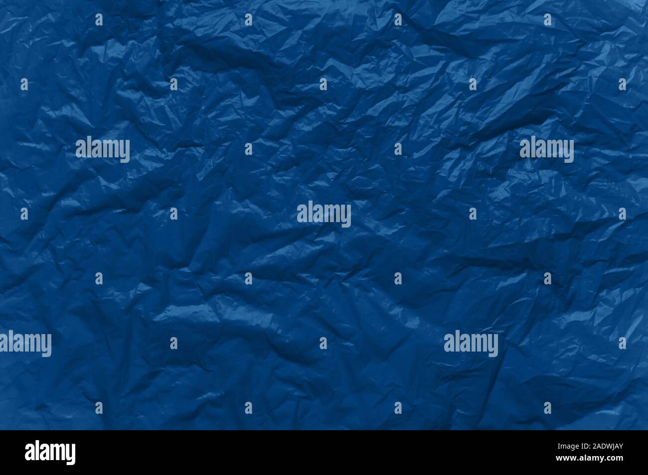 Abstract background in blue. Crumpled plastic surface. Top view. Stock Photo