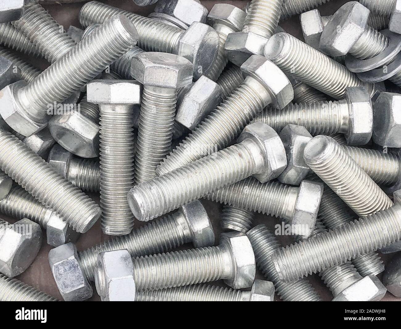 Steel bolts piled in the box. Fastening construction equipment. Fixing