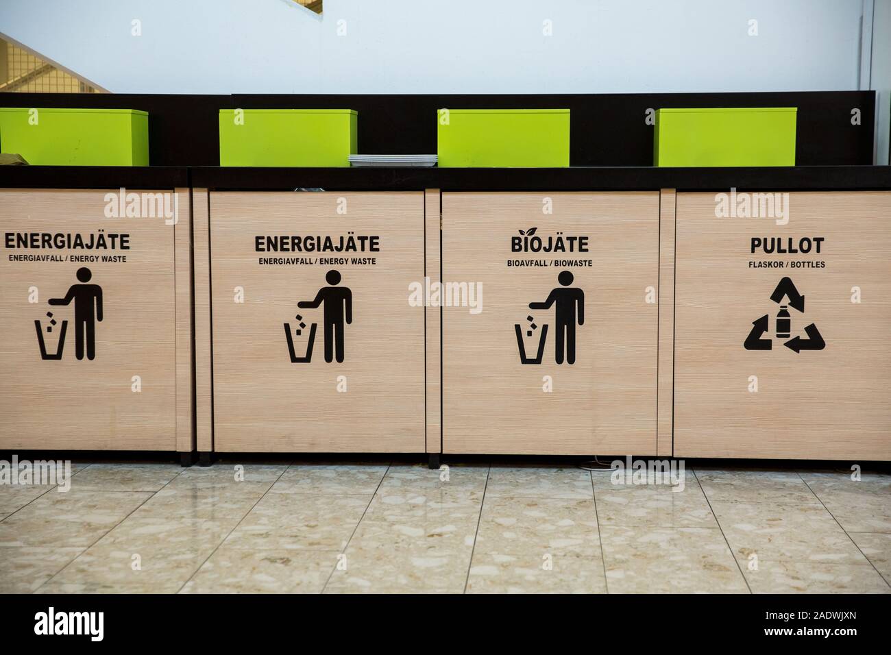 Trash bins in public area next to fast food restaurant, separating