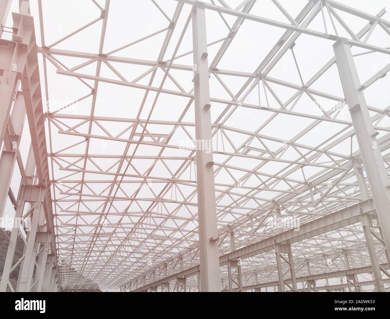 Metal frame of prefabricated multi-storey building. Metal pillars, beams and diagonal bracings Stock Photo