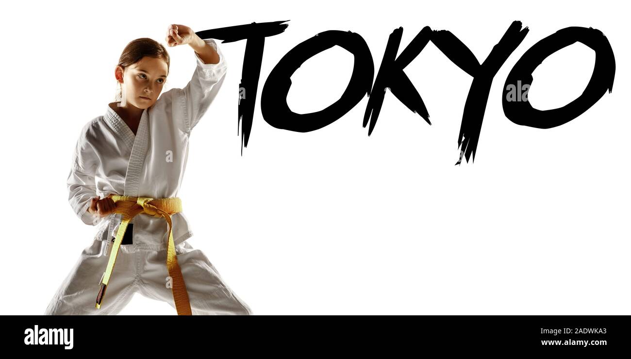 Tokyo, Japan, Olympic games in 2020. Confident junior in kimono practicing hand-to-hand combat, martial arts. Fighter with yellow belt's training. Concept of healthy lifestyle, sport. Flyer for ad. Stock Photo