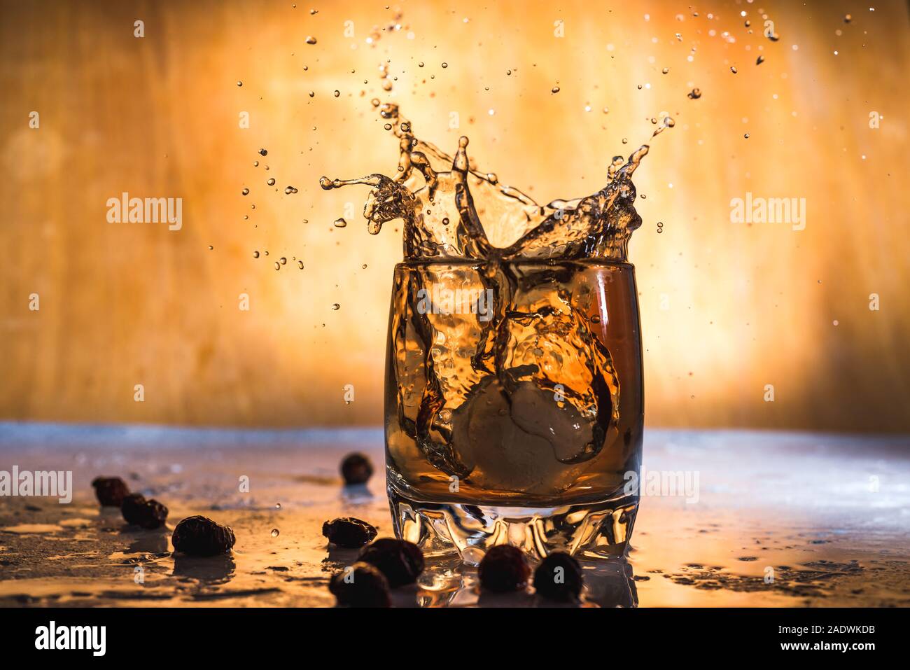 https://c8.alamy.com/comp/2ADWKDB/splash-of-cold-ice-in-glass-of-whiskey-isolated-on-a-light-background-2ADWKDB.jpg