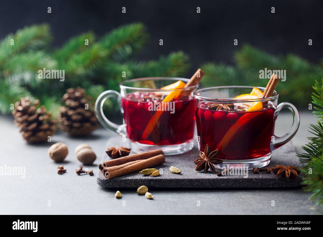 Mulled red wine with spices. Christmas decoration. Grey background. Copy space Stock Photo
