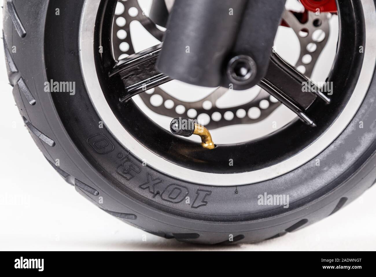 The inflatable wheel of the electric scooter is closeup Stock Photo