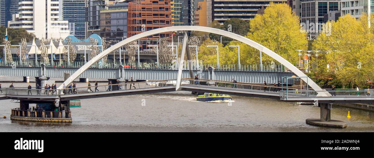 Evan Walker Bridge pedestrian bridge footbridge crossing the Yarra River and Sandride bridge in background, Melbourne Victoria Australia. Stock Photo