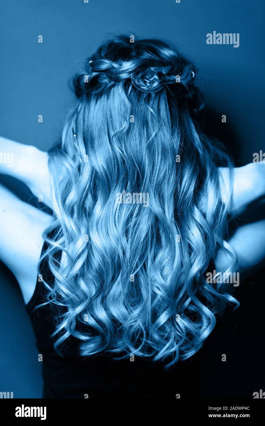Back View Of Young Woman With Modern Hairstyle Toned In Blue Color