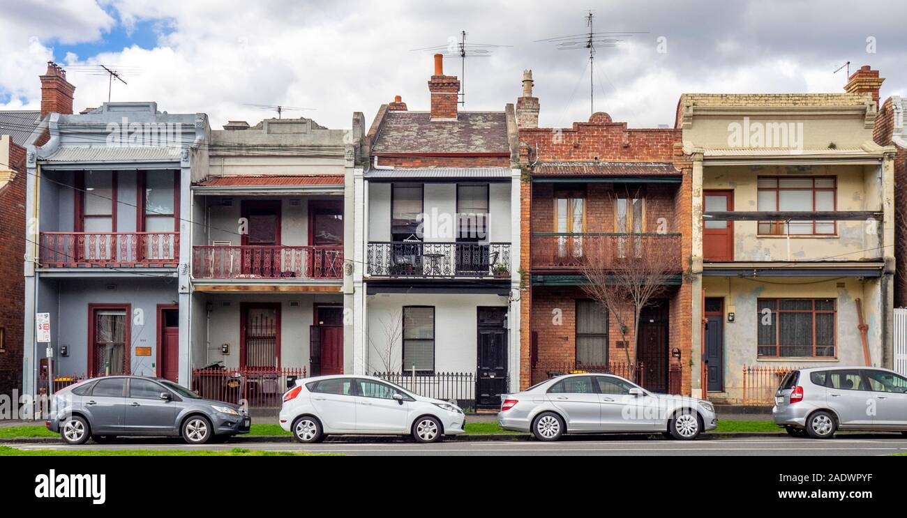 Drummond Street parked cars in front of a row of terrace houses in