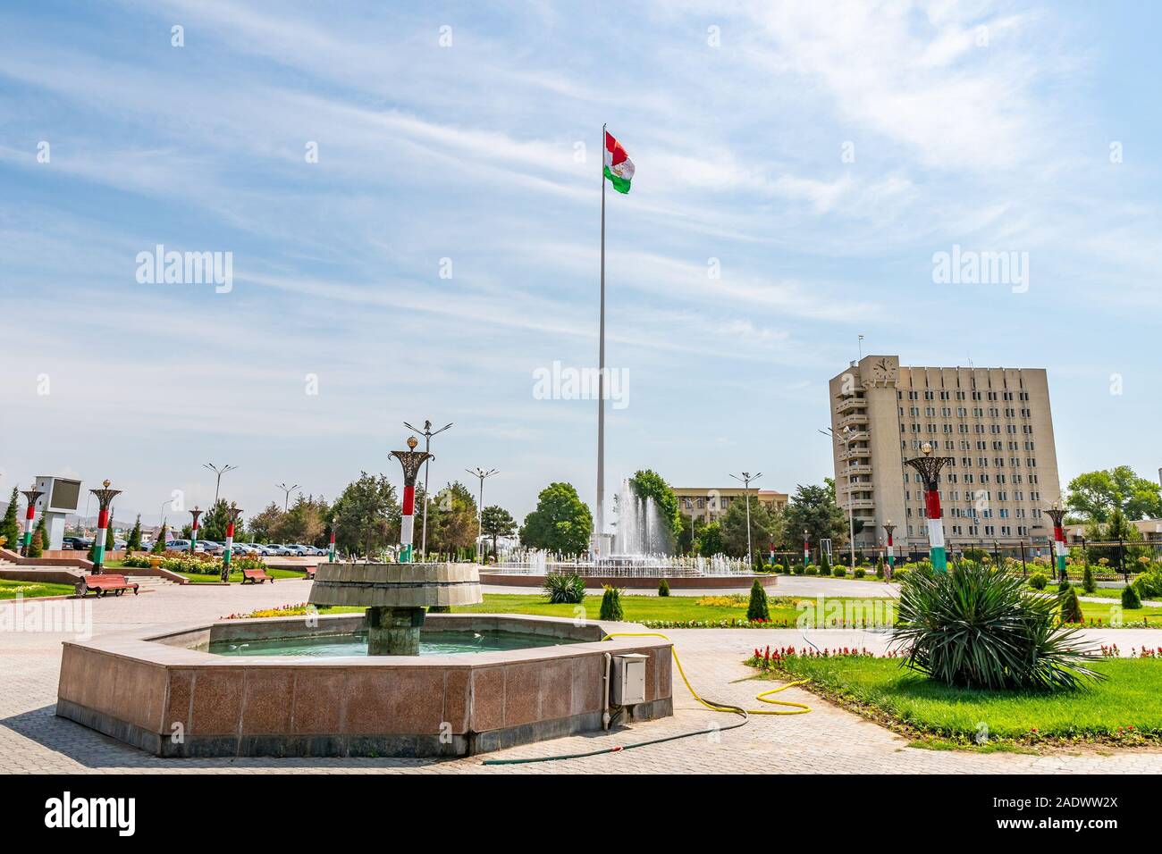 Khujand Waving Tajikistan Flag near Sughd Hukumat City Region Government on a Sunny Blue Sky Day Stock Photo