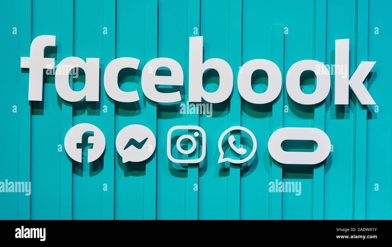 COLOGNE, SEPTEMBER 2019: Facebook logotype with Instagram, Whatsapp, Oculus and Messenger logos on a wall at the DMEXCO trade fair Stock Photo