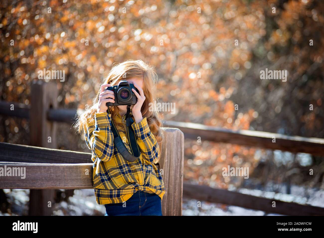 Young Girl Hiking and Taking Pictures in the Mountains Stock Photo