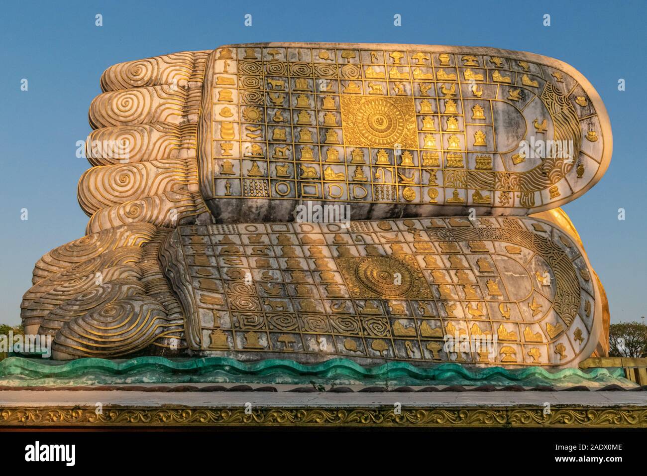 Giant reclining Buddha statue in Bago, Myanmar - close-up of the intrinsicly decorated feet of the statue. Stock Photo
