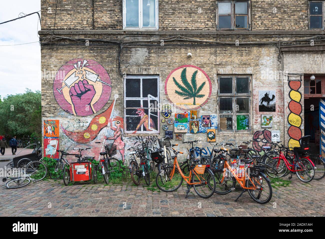 Christiania Freetown, view of an illustrated building and parked bicycles in the alternative Freetown area of Christiania, Copenhagen, Denmark. Stock Photo