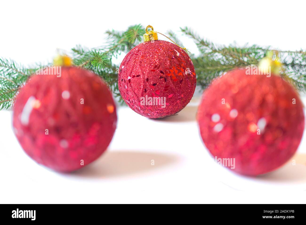 Three red baubles and pine branches isolated on white background ...
