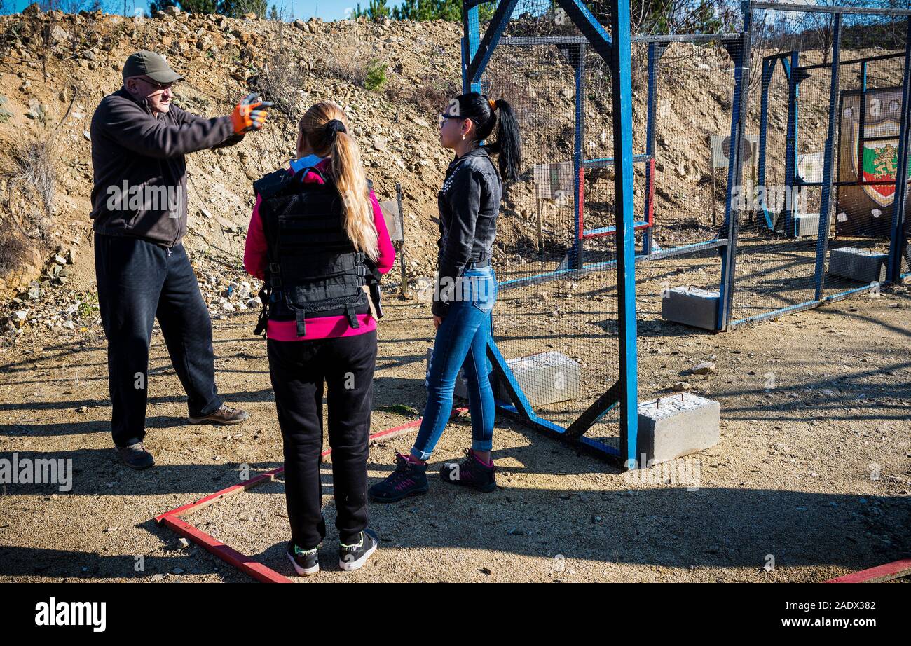 Nova Zagora Bulgarian Bulgaria December 2019: Visiting tourists enjoy a day  out shooting, learn the basics to be competent with a weapon safe  handledling and a controlled manner. The day starts with